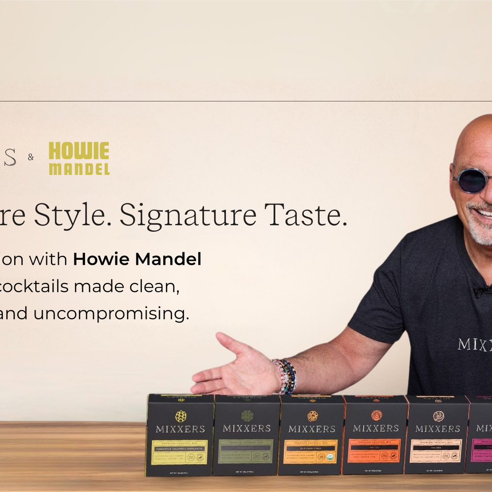 Howie Mandel standing behind a bar with Mixxers cocktail and mocktail mixers.