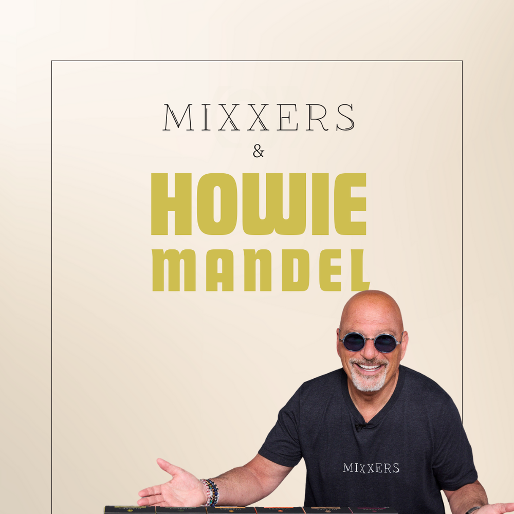Howie Mandel standing behind a bar with Mixxers cocktail and mocktail mixers.