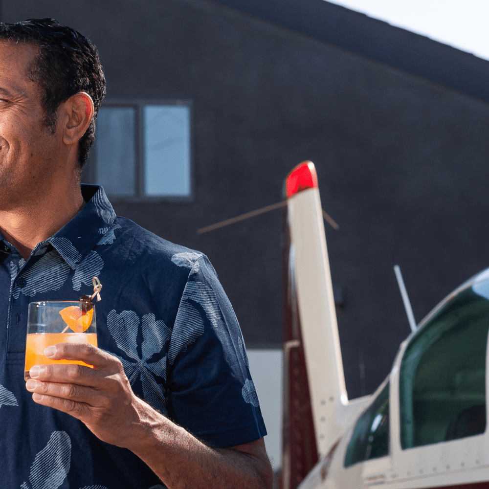 Mixxers Old Fashioned Cocktail Next To An Airplane